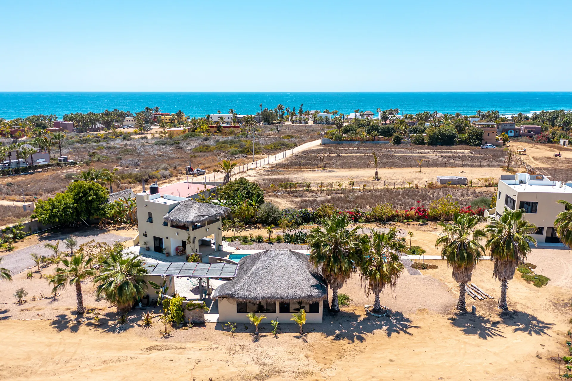 One acre divided into two lots, two one-bedroom casitas, a one-bedroom, one-bath house, yoga or art studio, sixty-foot heated lap pool, community kitchen with full bath and barbecue area.
